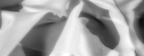 A soft, textured fabric in grayscale, displaying dynamic folds and shadow details in a seamless...
