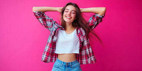 Smiling woman with plaid shirt against pink background, Happy young woman in front of bright pink wall, Casual smiling girl in colorful shirt on pink background