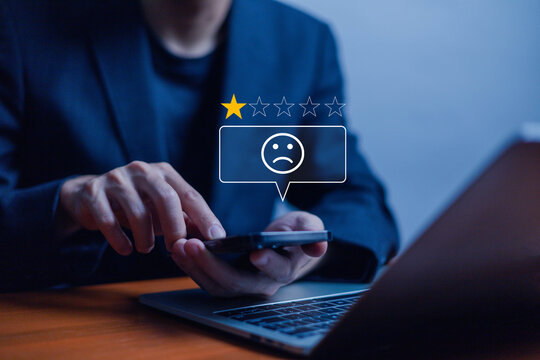Customer Experience dissatisfied Concept. Unsatisfied customer, User via a smartphone reviews a 1-star rating, Negative feedback bad, bad service, Sadness emotion customer