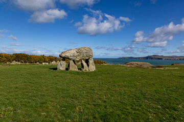 Carreg Samson in Pembrokeshire, with a blue sky overhead