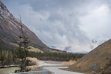 Mountain road and valley of Chuysky Trakt Altai Russia. Scenic route through rugged terrain and...