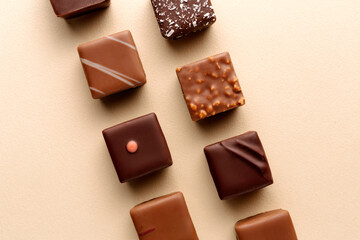Minimal chocolate squares flatlay on beige background, elegant candy dessert concept