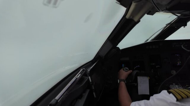 A real time flight experience through the pilot eyes from inside a jet airplane flying through a stormy sky full of storm clouds.