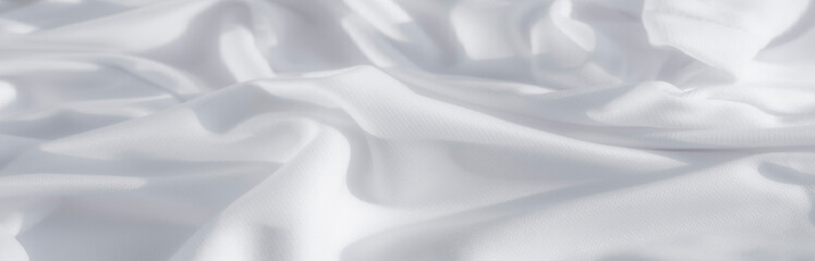 In a blur of silky radiance, this crisp white fabric draws the eye toward its softly curved fold, reflecting gentle light and emanating an aura of peaceful elegance, instilling a quiet tranquility.
