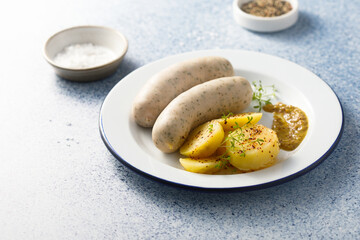 White sausages with potato salad and mustard
