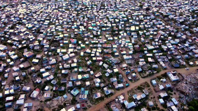 Overpopulation in squatter camp with makeshift houses, poverty in RSA. Drone