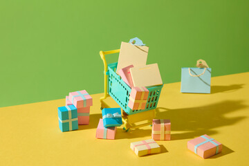 A creative paper-cut composition featuring a shopping trolley with colorful items, representing retail therapy and fun weekend purchases in a minimalist style.
