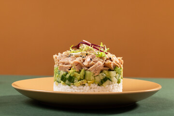 Tinned tuna salad on a plate with beer rice and other snacks in a modern interior, food art