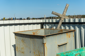 Forgotten Cross: A Weathered Symbol of Loss and Remembrance in an Abandoned Cemetery. Echoes of the Past: An Old Cross Discarded Amidst New Memories in a Quiet Graveyard.