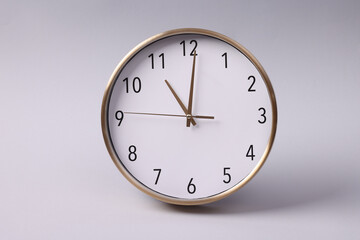 Close-up of a wall clock. The concept of time and work time is valuable for life, Alarm clock stopped. photo in a coloured background