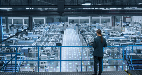 Factory Digitalization Visual Transformation: Female Engineer Uses Laptop to Activate Construction...