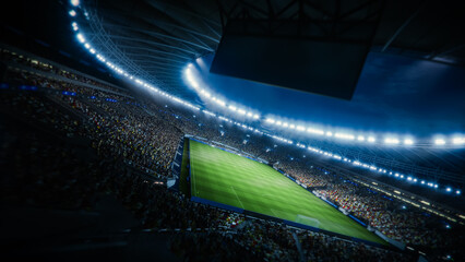 Aerial View of a Soccer Stadium at Night. Field, Goalposts, and a Large Crowd Are Visible. Photo...