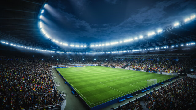 Night Drone Flight Around a Soccer Stadium. Aerial Views Capture the Pitch and Stands Filled With Thousands of Spectators. Arena Hosts a Major Sport Event
