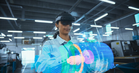 Female Engineer Wearing Ar Headset Works on a 3d Green Energy Engine Turbine Model in a High-tech Factory, Utilizing Interactive Software Interfaces and Advanced Digital Machinery.