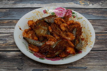 A savory seafood and vegetable dish, featuring prawns and eggplants coated in rich chili sauce.