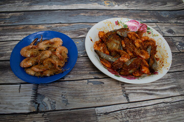 Savory fried prawns arranged on a wooden table, perfect for home-cooked meals.