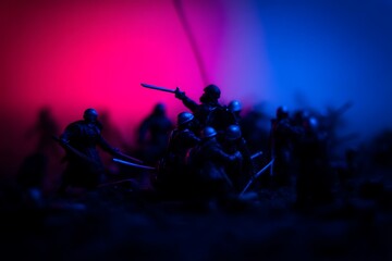 Miniature soldiers clash dramatic blue red lighting