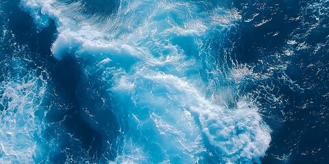 Aerial Ocean View: Deep Blue Waters and White Foam Swirl in Turbulent Pattern