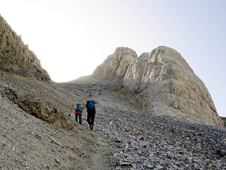 Two hikers climb the Escupidera on the ascent towards Monte Perdido, in the Ordesa National Park in Spain