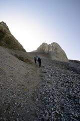 Two hikers climb the Escupidera on the ascent towards Monte Perdido, in the Ordesa National Park in Spain