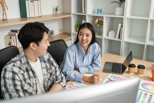 UX and UI Collaboration. Designers discussing project ideas in a modern workspace.