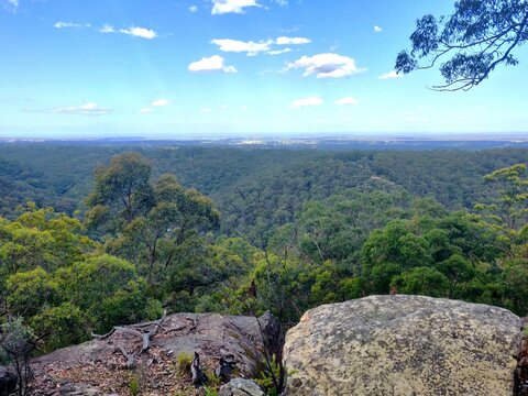 View of the green rolling hills and large rocks of the Blue Mountains from Bowen Mountain, Sydney, Australia