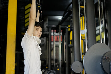 man exercising in a gym surrounded by fitness equipment and machines