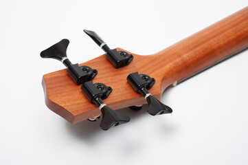 Four-string bass ukulele with wooden body and built-in tuner and pickup.