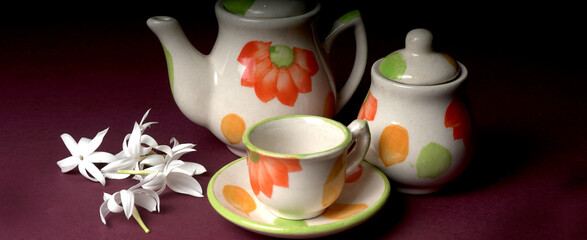 Indian masala chai or tea in cup, with kettle, spices and tea leaves on dark, wooden background. cafe, retro, restaurant, vintage, ethnic, healthy, hotel concepts.