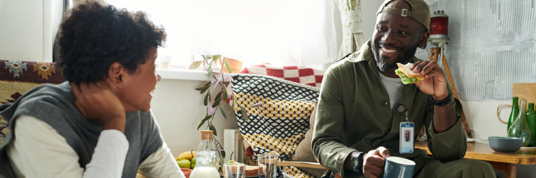 Smiling Friends Enjoying Conversation at Home Header