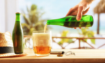 Drinking beer on table with appetizers on beach terrace