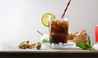 Refreshing carbonated cola drink on table with white isolated background