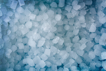 Blue background with a pile of small ice cubes top