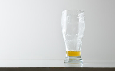 Empty and dirty beer glass with foam isolated on table