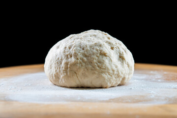 yeast dough on a wooden board. Fresh baked goods. Food. Bread. The concept of food