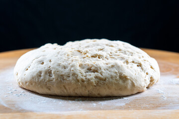 yeast dough on a wooden board. Fresh baked goods. Food. Bread. The concept of food