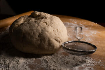 yeast dough on a wooden board. Fresh baked goods. Food. Bread. The concept of food