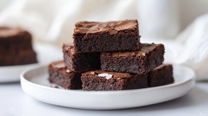 Deliciously rich chocolate brownies stacked on a plate, perfect for dessert lovers and sweet treat enthusiasts.