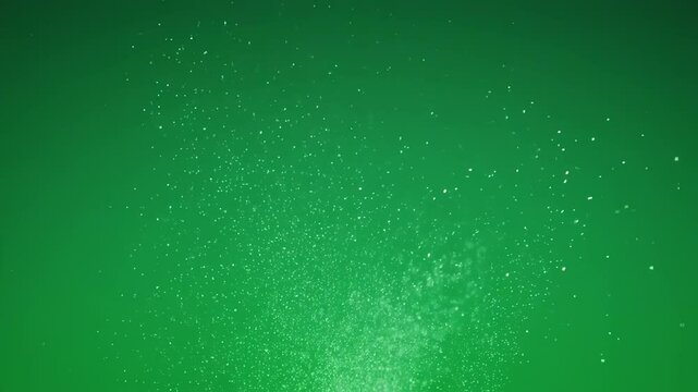 Vibrant green background with sparkling particles creating a dreamy and ethereal atmosphere