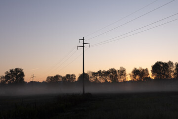 silhouette of electricity power poles at dawn