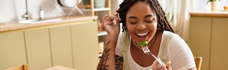 Joyful moments of a young woman enjoying a fresh salad at home during lunch