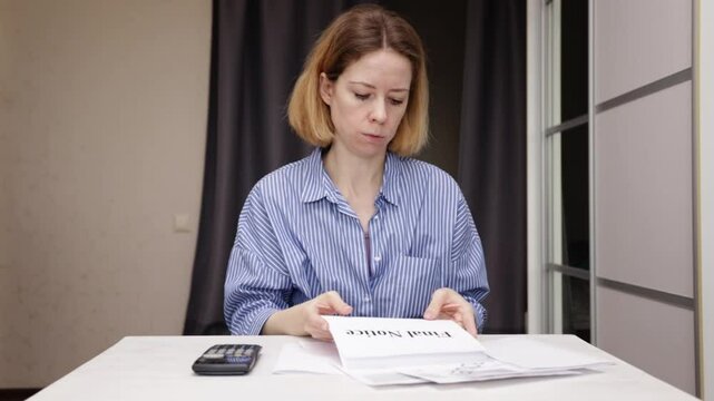 Stressed woman with debt utility bill, shocked by rising energy costs, final payment warning
