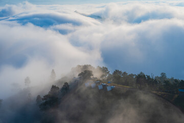 Fototapeta premium The beautiful natural landscape is a sea of mist in the morning, the movement of the fog covering the Mountain—tourism to enjoy the natural beauty of Mae Chaem, Chiang Mai, Northern Thailand.