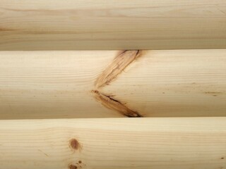 Close-up of unpainted log texture. Beautiful natural pattern of unpainted logs. Wooden background