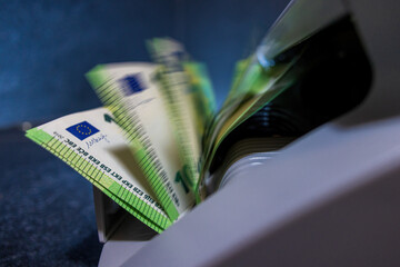 100 Euro banknotes beeing counted in a banknote counting machine
