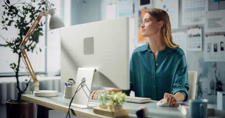 Portrait of Smiling Caucasian Female Specialist Working on Computer. Her Modern Workspace, Creativity and Digital Problem solving. Modern Designer Room