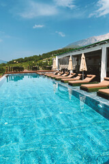 Hotel Infinity Pool and Sun Loungers in Summer