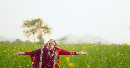 Indian adult gen x beautiful model woman lady wear red traditional saree enjoy outdoor nature Asian...