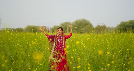 Indian adult gen x beautiful model woman lady wear red saree standing enjoy outdoor nature asian...