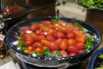 Assortment ripe cherry tomatoes, rotation. cherry tomatoes cocktail tomato covered with fly film frequency neatness freshness waiting for guests in buffet